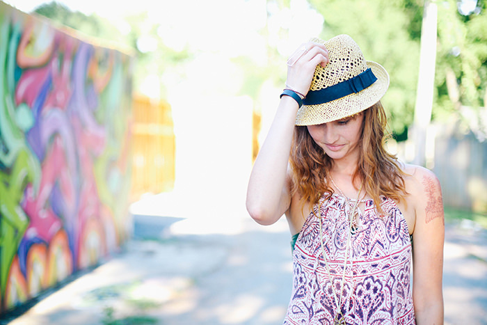 Girl holding her hat down