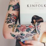 Tattooed girl holding a book