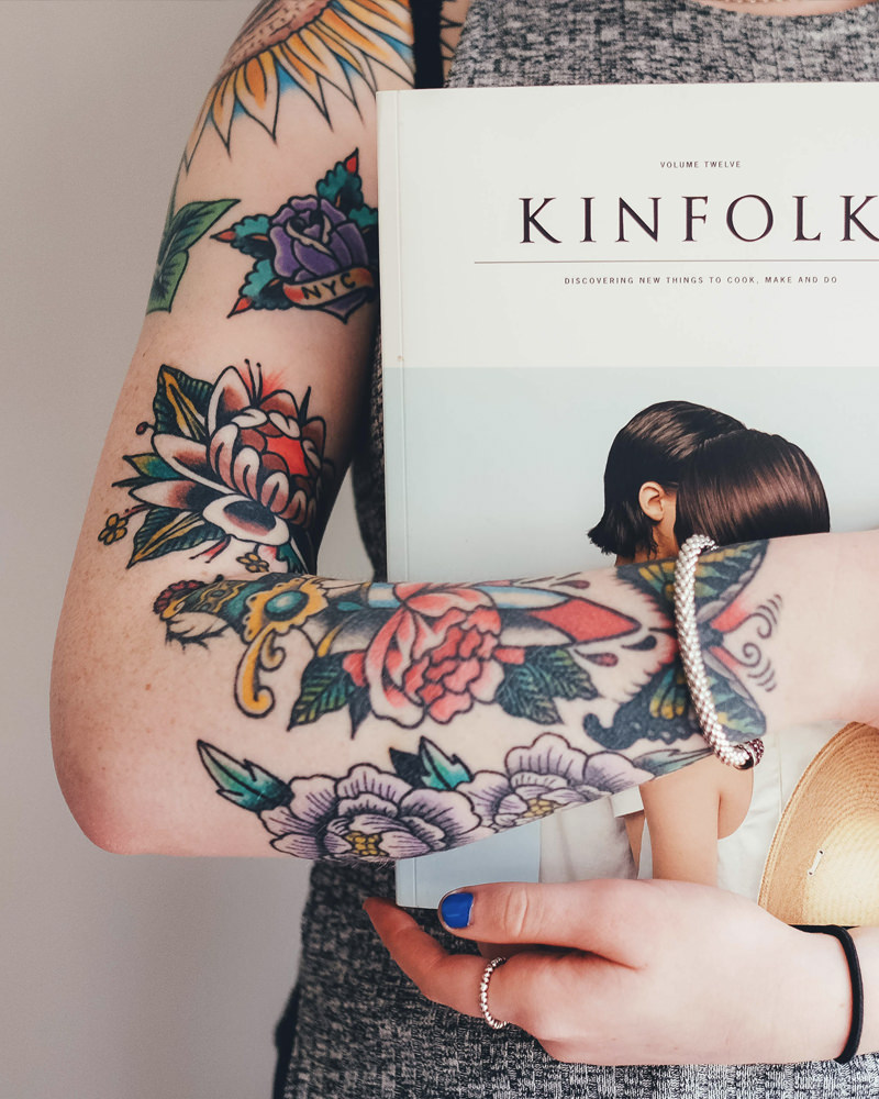 Tattooed girl holding a book